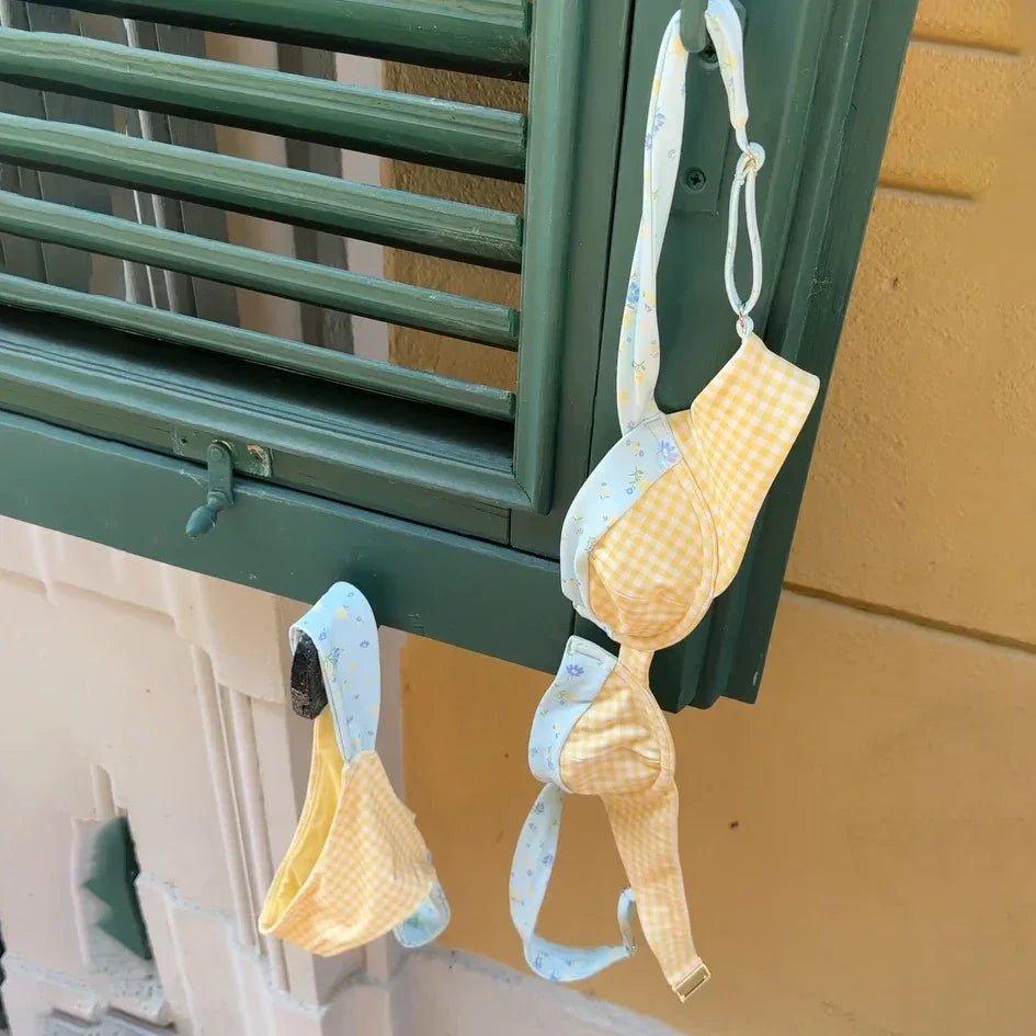 Yellow gingham floral bralette hanging on green shutter, women's fashion lingerie