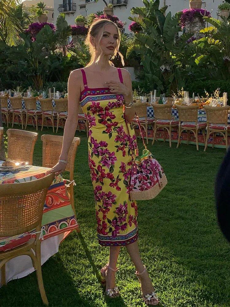 Woman in yellow floral midi dress at outdoor garden party, summer fashion