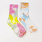 Colorful tie-dye women's fashion socks with pink, yellow, blue, and orange patterns on white background