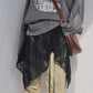 Gray graphic tee with black lace overlay, beige pants, and brown crossbody bag for women's fashion