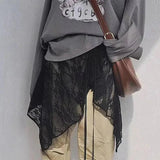 Gray graphic tee with black lace overlay, beige pants, and brown crossbody bag for women's fashion
