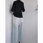 Black top with white lace overlay and light blue wide-leg jeans for women's fashion