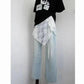 Stylish women's outfit with lace overlay, black graphic tee, and light blue wide-leg jeans