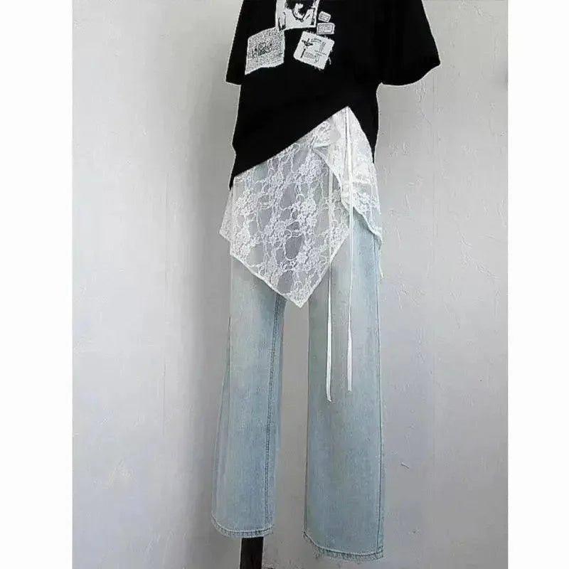 Stylish women's outfit with lace overlay, black graphic tee, and light blue wide-leg jeans