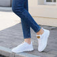 White women's mesh sneakers with gold accent, paired with blue jeans, perfect for casual fashion