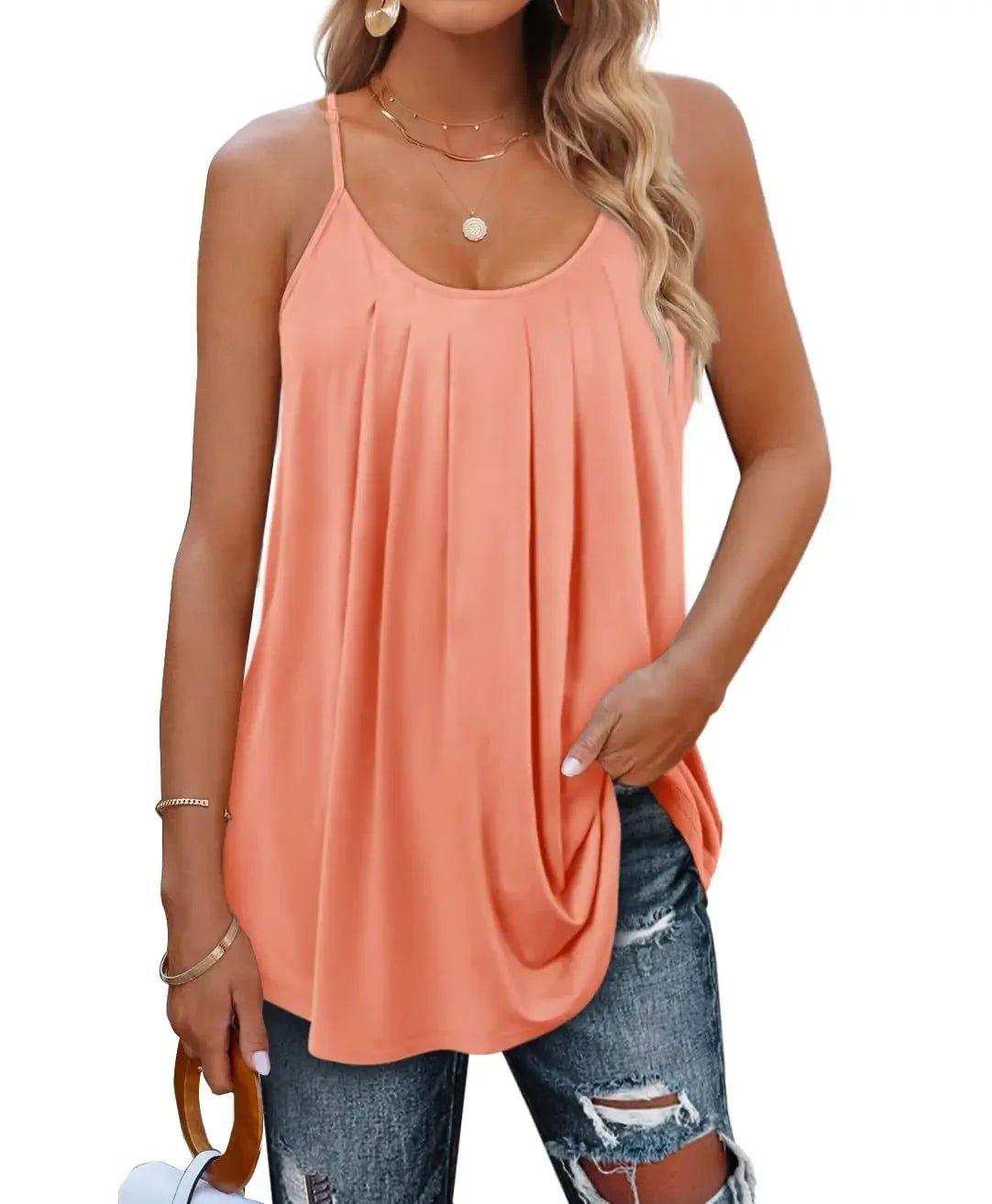 Peach pleated camisole top with thin straps, paired with ripped jeans for casual women's fashion