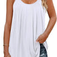 White pleated camisole top with thin straps, paired with ripped jeans for casual women's fashion