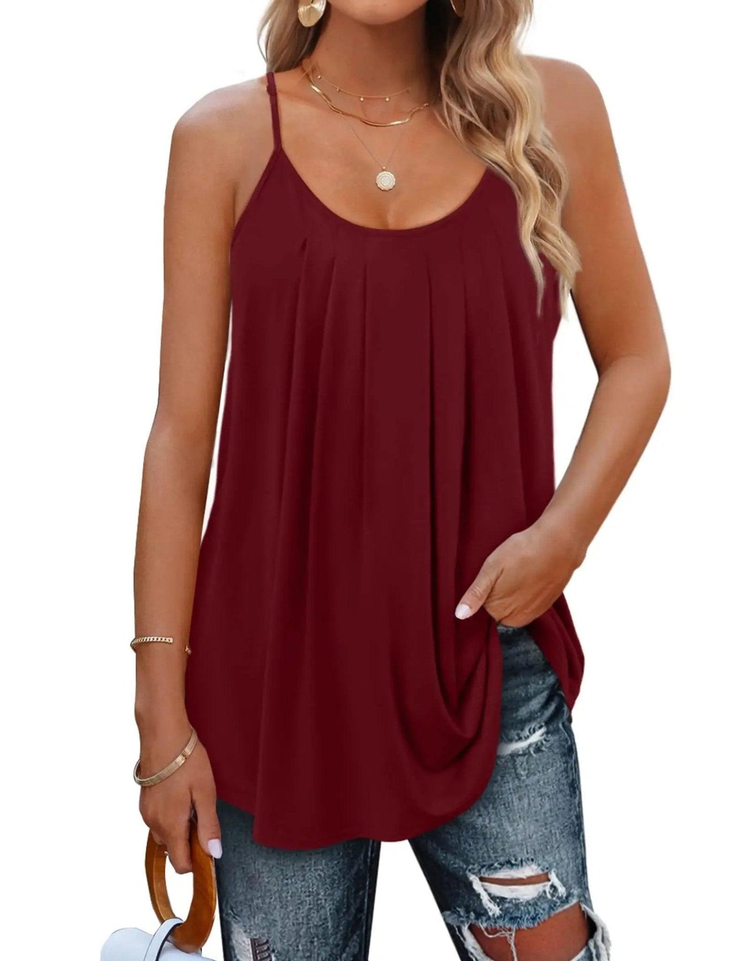 Burgundy women's flowy cami top with thin straps, paired with ripped jeans and gold jewelry for casual fashion.