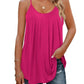 Pink women's flowy tank top with spaghetti straps, paired with ripped jeans and gold jewelry