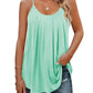 Mint green women's pleated camisole top with thin straps, paired with ripped jeans and gold jewelry