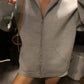 Woman wearing gray zip-up hoodie with front pockets, casual fashion outfit