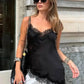 Woman in black lace camisole top and white shorts, stylish streetwear fashion