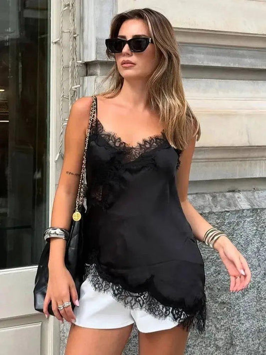 Woman in black lace camisole top and white shorts, stylish streetwear fashion
