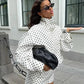Woman in white polka dot fashion set with black clutch and sunglasses, street style