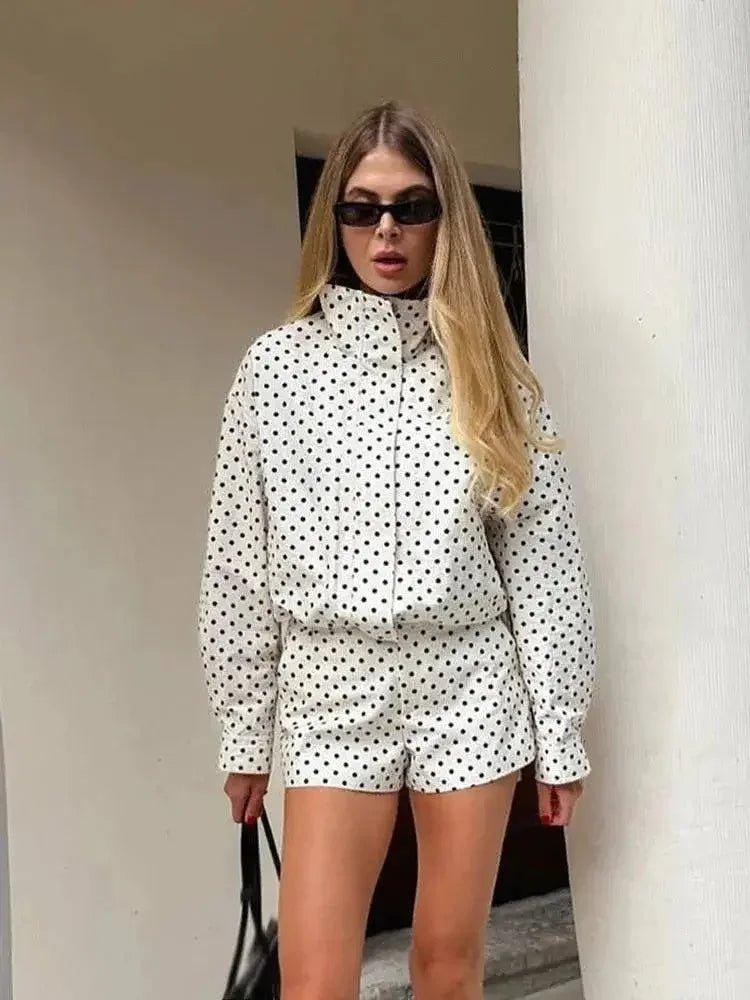 Woman in white polka dot long sleeve top and matching shorts, stylish summer outfit
