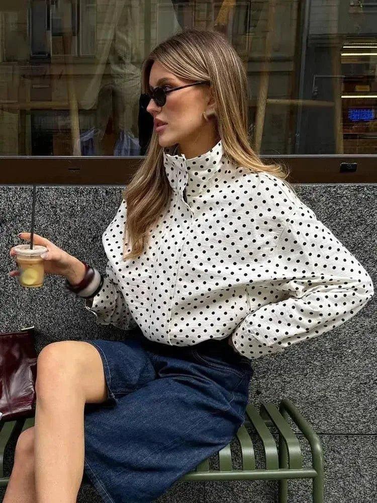Woman in polka dot blouse and denim skirt, stylish street fashion