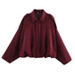 Burgundy women's fashion blouse with cape sleeves and collar detail