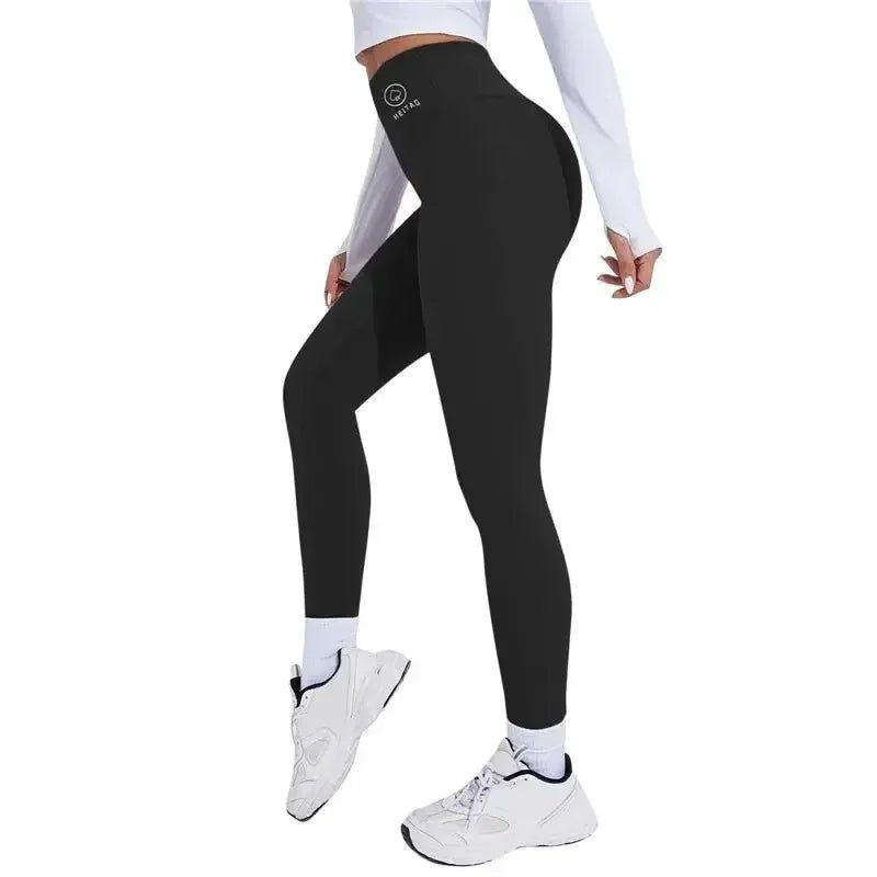 Black high-waisted leggings with logo, paired with white top and sneakers for women's fashion