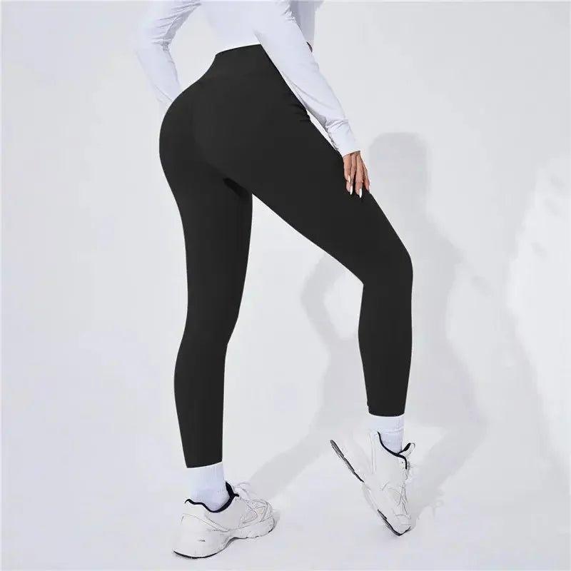Black high-waist leggings for women, perfect for gym, yoga, or casual wear with white sneakers.