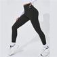 Black high-waisted workout leggings with logo, paired with white sneakers for women's fitness fashion