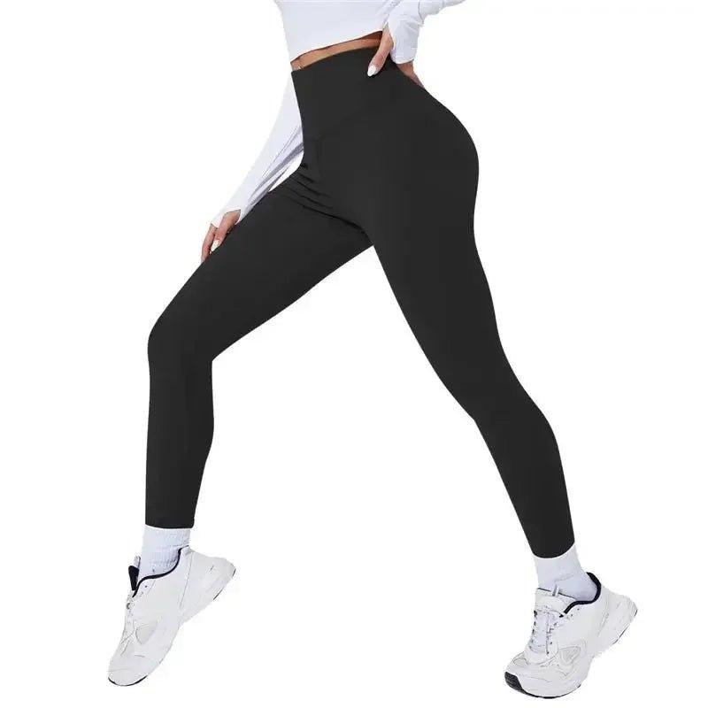 Black high-waist women's leggings with white sneakers, perfect for fitness and casual wear