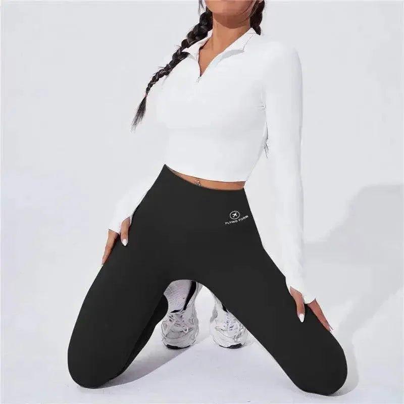 Woman in white crop top and black high-waist leggings, fitness fashion outfit