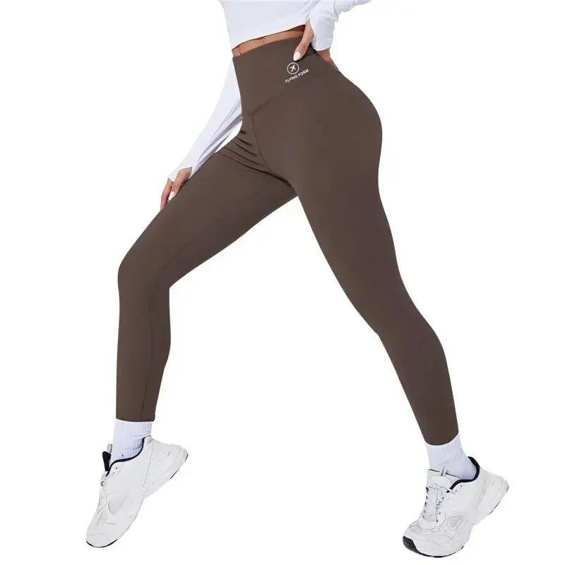 Women's high-waisted brown leggings with white sneakers, perfect for fitness and casual fashion
