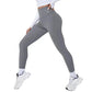 Gray high-waisted workout leggings for women, paired with white sneakers and crop top
