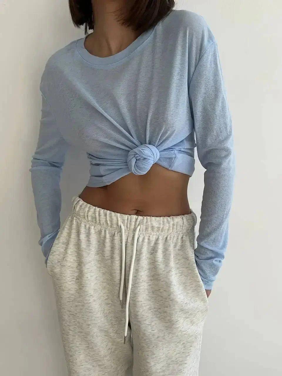 Light blue knotted long sleeve top with cream drawstring joggers, women's casual fashion outfit