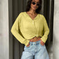 Woman in yellow knotted long sleeve top and denim shorts, stylish summer fashion outfit