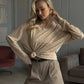 Woman in beige knotted long sleeve top and pinstripe shorts, stylish casual fashion outfit