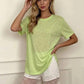 Woman in lime green oversized tee and white lace trim shorts, casual fashion outfit