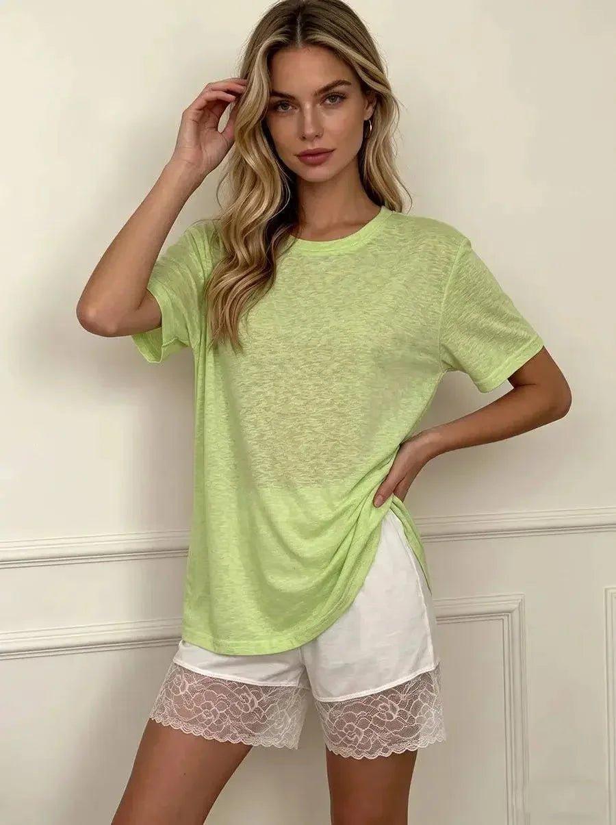 Woman in lime green oversized tee and white lace trim shorts, casual fashion outfit