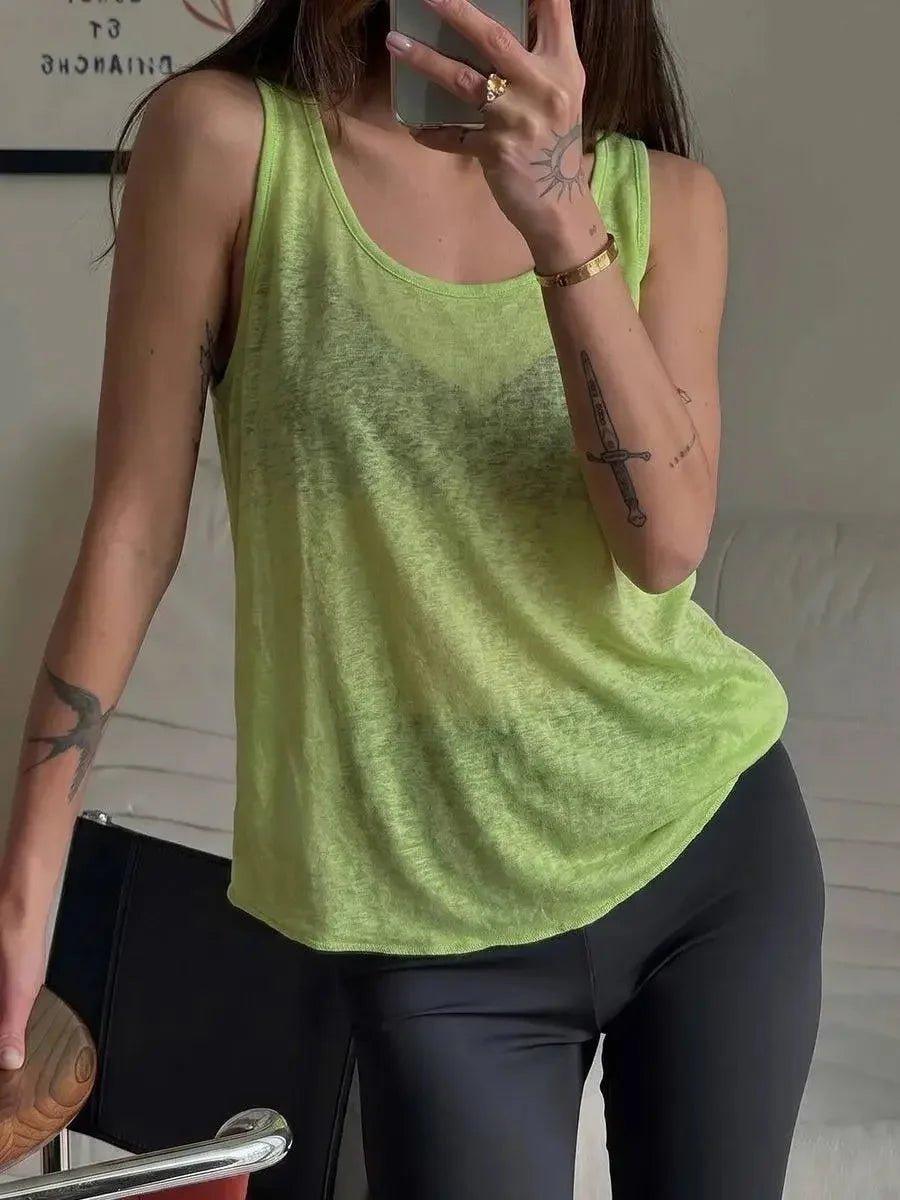 Lime green women's tank top with relaxed fit, styled with black leggings for casual fashion