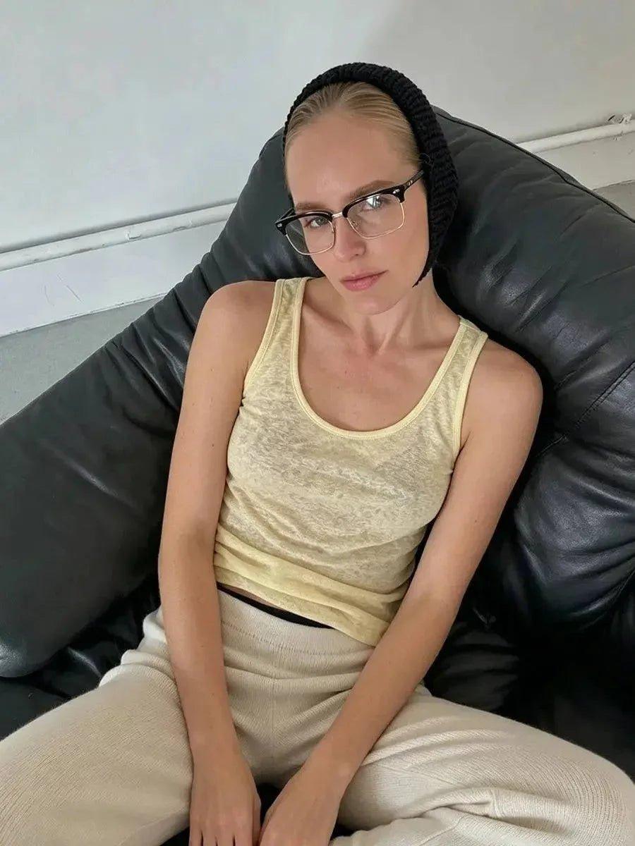 Woman in yellow tank top and knit headband, stylish casual fashion look