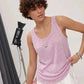 Woman in pink sleeveless top and white skirt, studio fashion shoot