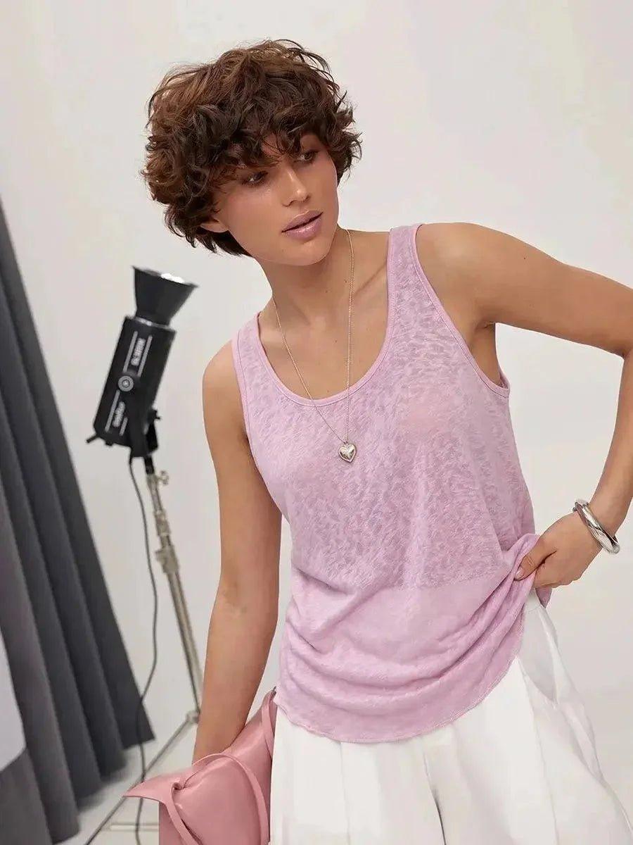 Woman in pink sleeveless top and white skirt, studio fashion shoot