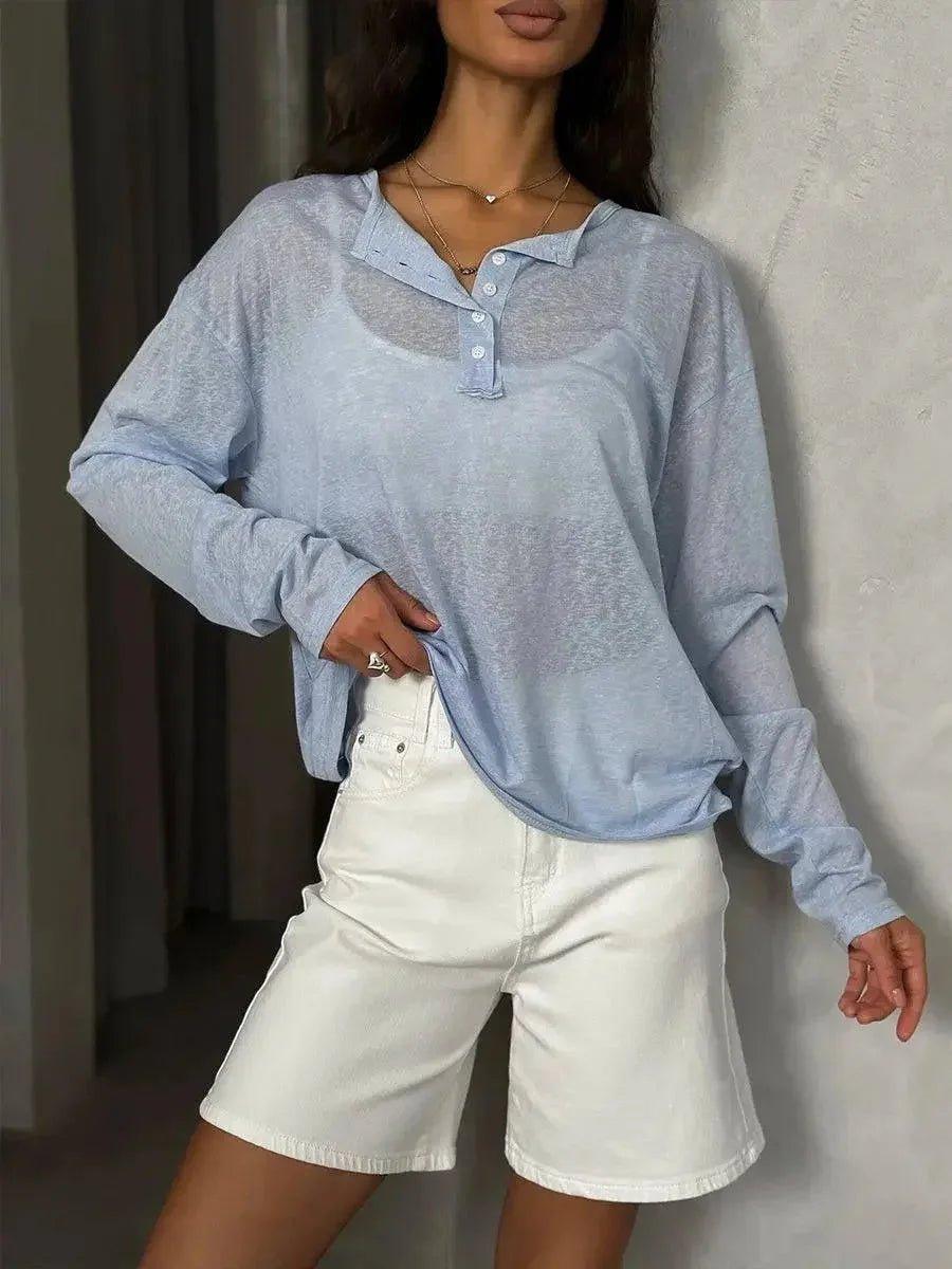 Woman in light blue long sleeve polo shirt and white denim shorts, casual fashion outfit