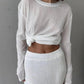 Woman in white knotted long sleeve top and mesh midi skirt, stylish fashion outfit
