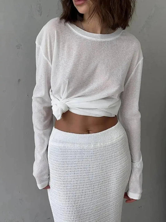 Woman in white knotted long sleeve top and mesh midi skirt, stylish fashion outfit