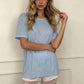 Woman in light blue oversized tee with white lace trim shorts, casual fashion