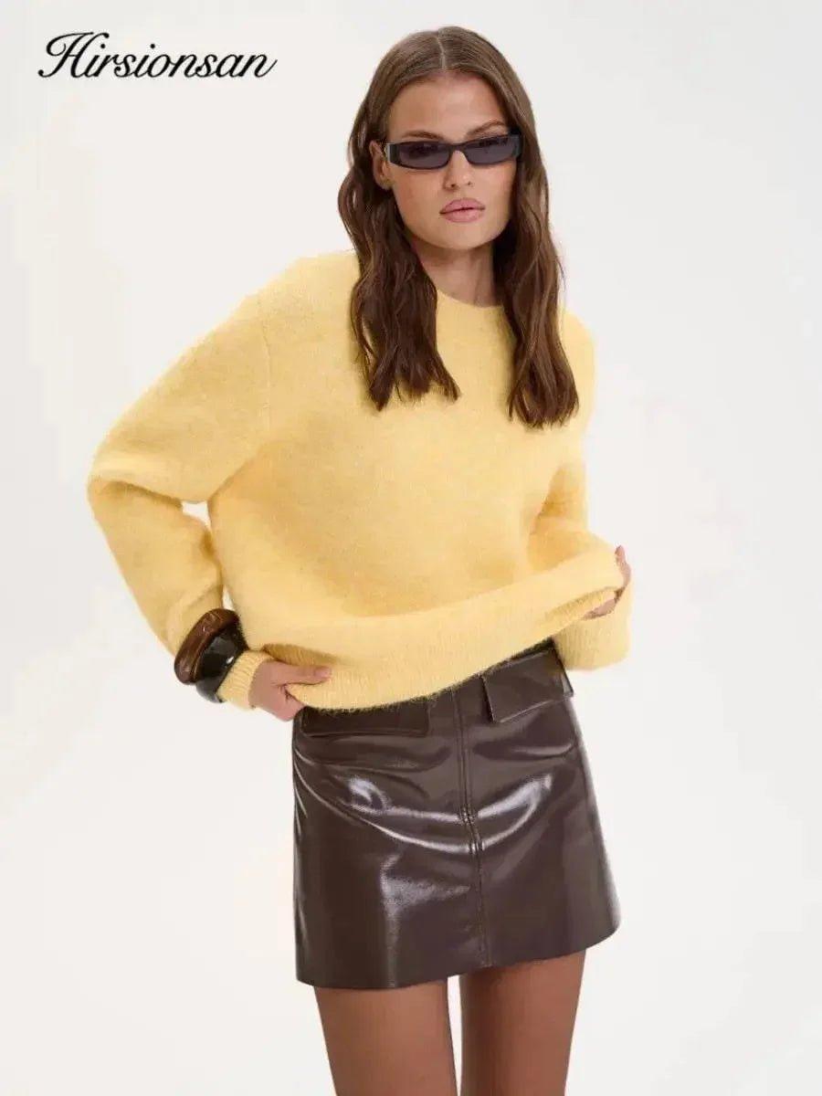 Woman in yellow fuzzy sweater and brown leather mini skirt, stylish fashion outfit