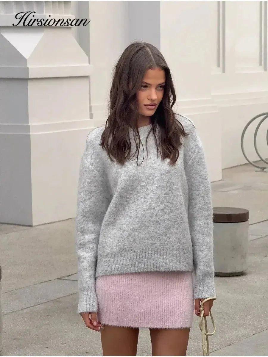 Woman in cozy gray sweater and pink knit skirt, stylish fall fashion outfit