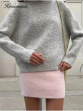 Woman wearing cozy gray sweater and pink knit mini skirt, stylish fall outfit