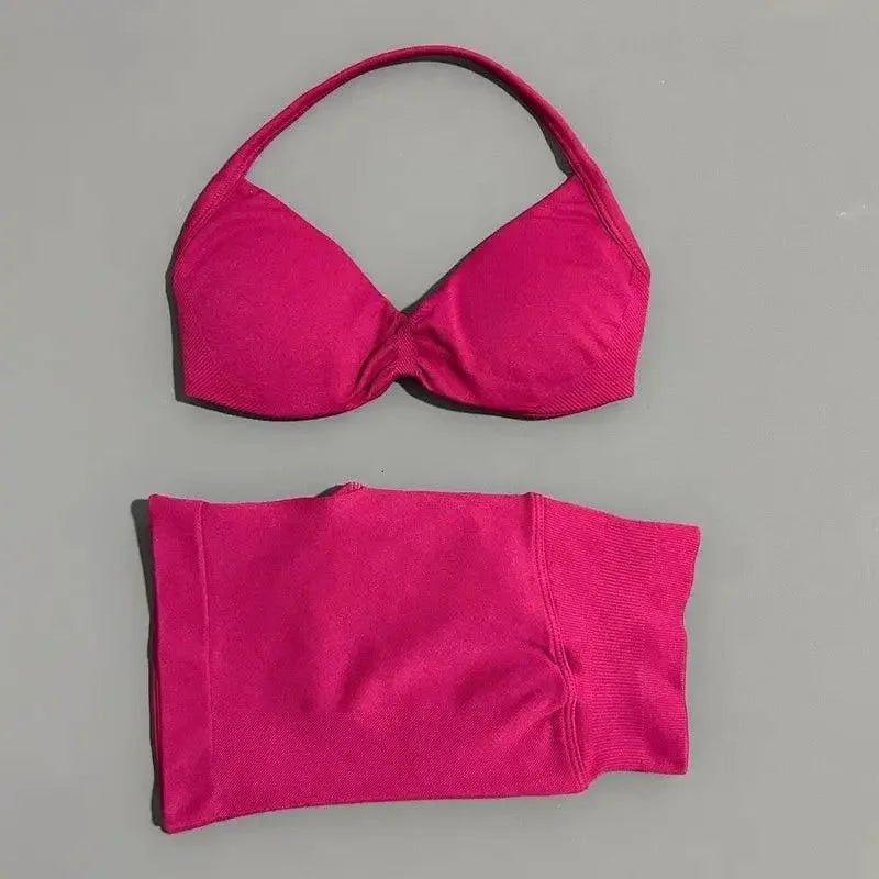 Bright pink women's bikini set with halter top and high-waisted bottoms, perfect for beach fashion.