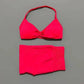 Vibrant red halter bikini set with knotted top and high-waisted bottoms, perfect for beach fashion.