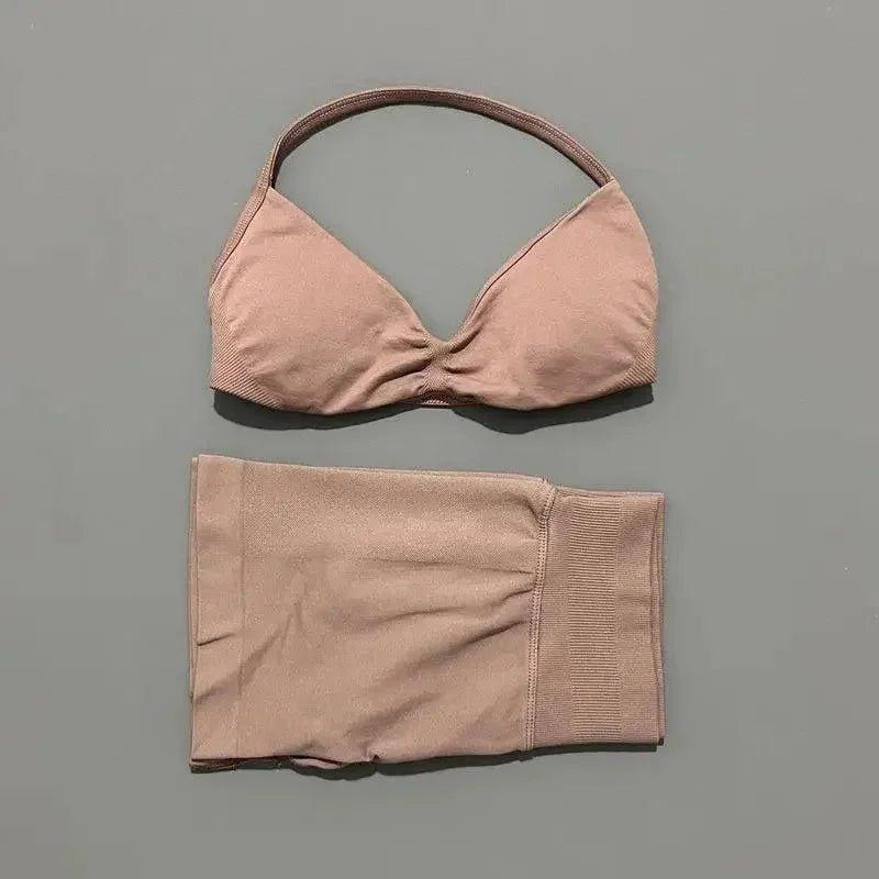 Pink women's bikini set with halter top and high-waisted bottoms, soft fabric, minimalist design