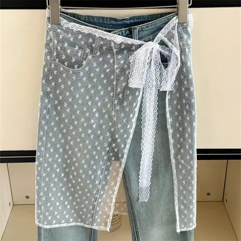 Lace-trimmed sheer wrap skirt with heart print over denim jeans, women's fashion
