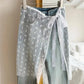 Sheer lace wrap skirt with bow print over denim jeans, women's fashion
