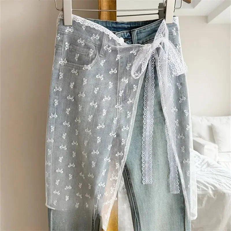 Sheer lace wrap skirt with bow print over denim jeans, women's fashion
